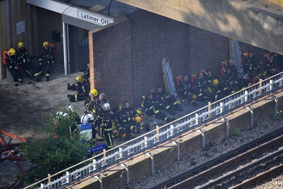 Após o assolador incêndio no Grenfell Tower, bombeiros sentam-se à sombra para descansar - 17/06/2017