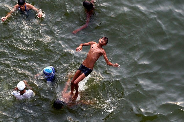 Garoto se diverte no rio Yamuna, durante um dia quente de verão na Índia - 16/06/2017