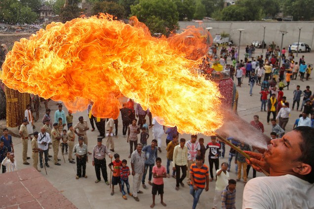 A Hindu devotee performs a stunt with fire during the Jal Yatra procession ahead of the annual Rath Yatra, or chariot procession, which will be held on June 25, in Ahmedabad, India, June 9, 2017. REUTERS/Amit Dave     TPX IMAGES OF THE DAY