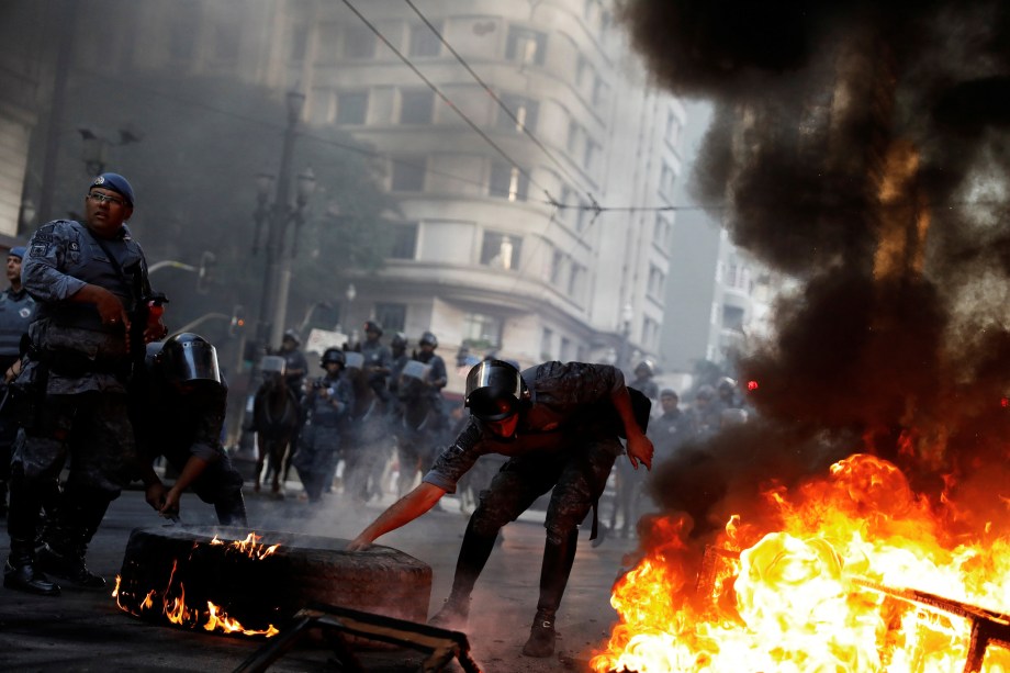 Policiais desarmam barricada feita por manifestantes durante protesto contra as reformas econômicas propostas pelo presidente Michel Temer nesta manhã em São Paulo.