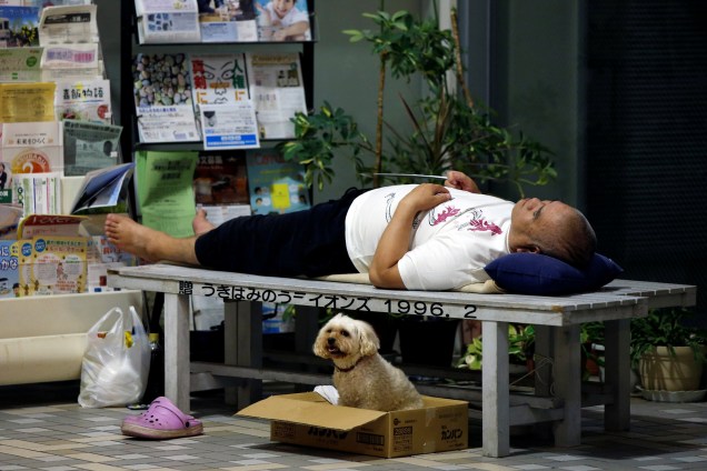 Um residente descansa no Centro de Educação de Asakura que está sendo usado como um centro de evacuação para as pessoas atingidas pela forte chuva no Japão, em Prefeitura de Fukuoka.