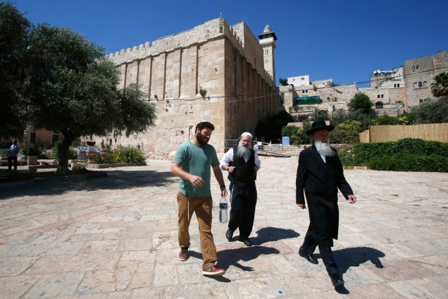 Judeus ultra-ortodoxos caminham nos arredores da caverna dos Patriarcas, também conhecida como Mesquita de Ibrahimi, local sagrado para judeus e muçulmanos, no coração da cidade de Hebron no sul Cisjordânia