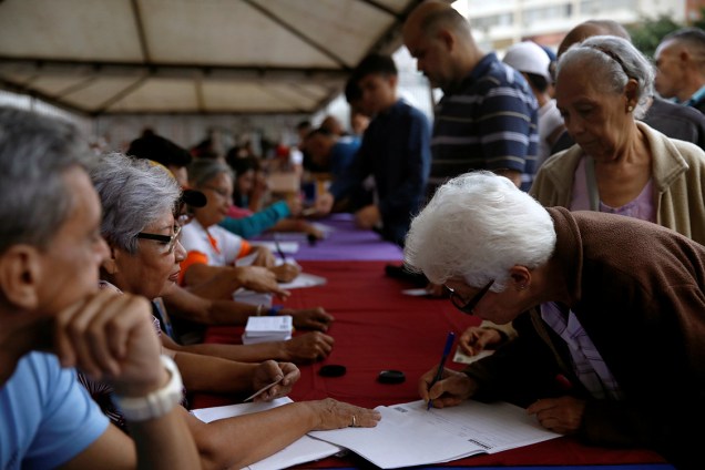 Mulher assina documento de plebiscito que vota contra o presidente Nicolas Maduro em Caracas, na Venezuela - 16/07/2017