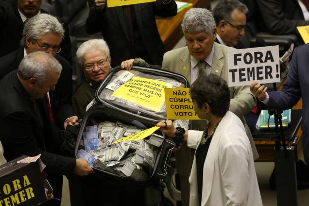 Oposição carrega mala com dinheiro falso e placas contra Temer durante o protesto na discussão da Câmara dos Deputados sobre a denúncia de corrupção passiva do Presidente - 02/08/2017 Oposição carrega mala com dinheiro falso e placas contra Temer durante o protesto na discussão da Câmara dos Deputados sobre a denúncia de corrupção passiva do Presidente - 02/08/2017