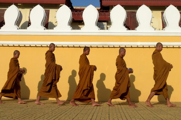 Monges budistas caminham em frente ao Palácio Real em Phnom Penh no Camboja - 09/08/2017