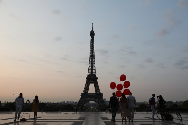 Pessoas visitam a praça do Trocadéro, em Paris, com a Torre Eiffel ao fundo, durante o amanhecer desta sexta-feira - 25/08/2017