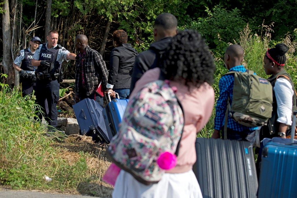 Família de refugiados haitianos tentam atravessar a fronteira entre Estados Unidos e Canadá