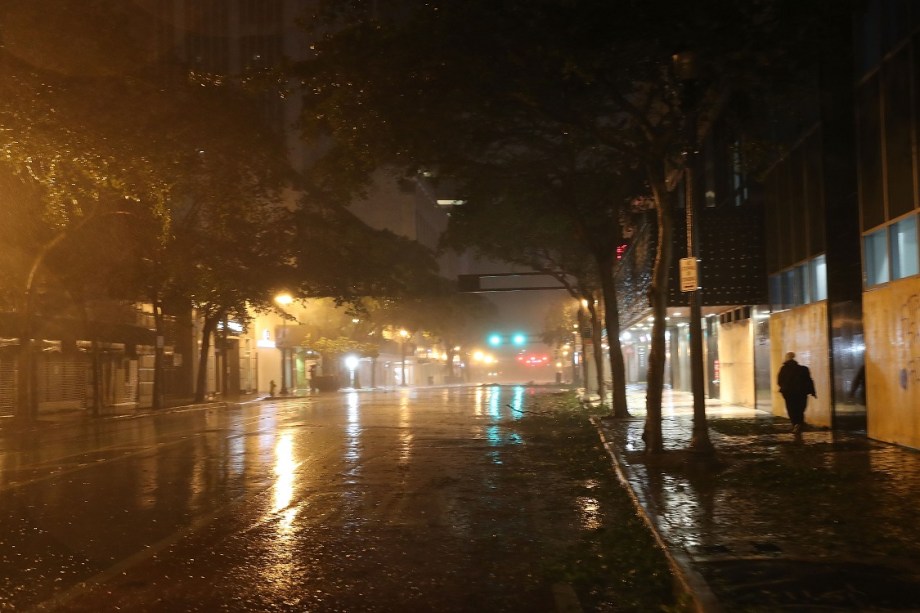 Homem caminha por rua alagada durante tempestade causada pela aproximação do furacão Irma na costa sudeste dos Estados Unidos