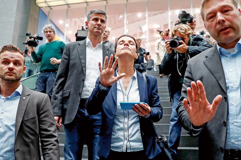 Frauke Petry (C), chairwoman of the anti-immigration party Alternative fuer Deutschland (AfD) reacts as she leaves a news conference in Berlin, Germany, September 25, 2017. REUTERS/Fabrizio Bensch TPX IMAGES OF THE DAY