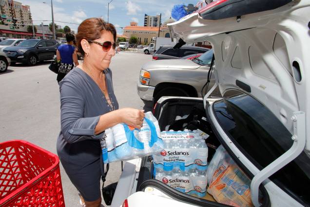 Moradora carrega carro com água e suprimentos, durante preparação para a chegada do furacão Irma, em Miami