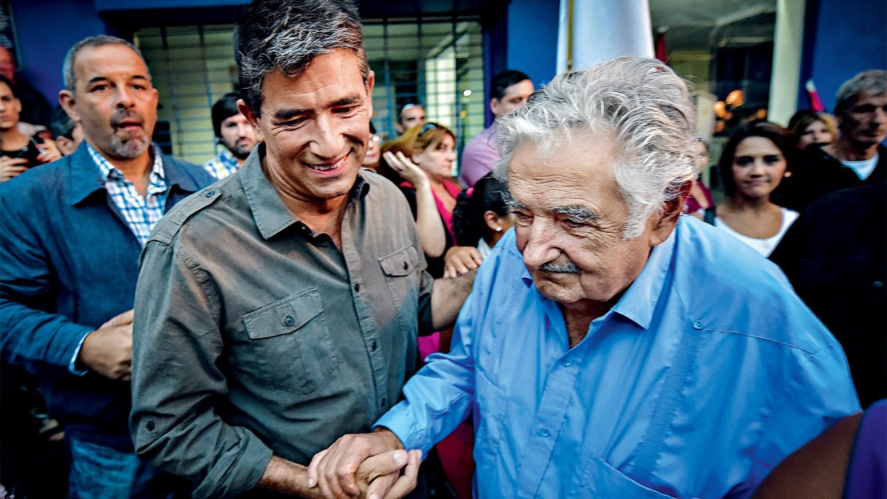 CANELONES, URUGUAY - MARCH 26: The current vice president of the Republic of Uruguay, Raul Sendic (2nd L) shakes hands with Former president and referent of the left in Uruguay, Jose "Pepe 'Mujica (R) as they attend the 46th anniversary celebrations of the establishment of the Frente Amplio in Las Piedras, Canelones on March 26, 2017. 46 years after the first act of the Frente Amplio, literally meaning Broad Front, the main leftist coalition and political force that governed since 2014 in Uruguay, commemorated this date in the city of Las Piedras calling the internal fraternity in the debate of ideas, in the corresponding areas. Carlos Lebrato / Anadolu Agency