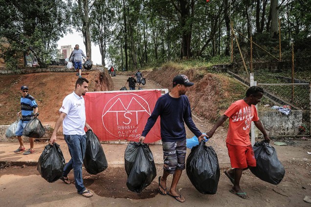 Militantes recolhem lixo durante ocupação do Movimento dos Trabalhadores Sem Teto (MTST) em um terreno em São Bernardo do Campo