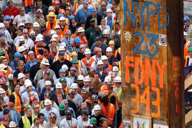Trabalhadores civis se reúnem durante retirada da última viga que ficou de pé após atentado do 11 de setembro às torres gêmes, em Nova York
