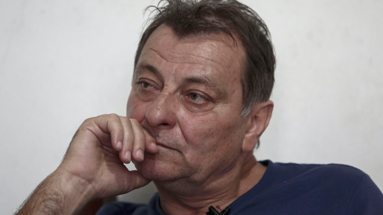 Italian ultra-leftist militant Cesare Battisti gestures during an interview with AFP in Cananeia, Sao Paulo state, Brazil on October 20, 2017. The Brazilian government wants to extradite former ultra-leftist militant Cesare Battisti to Italy, but will wait for the supreme court to resolve an habeas corpus filed by its lawyers to prevent it, Brazilian Justice Ministry Torquato Jardim said on October 13, 2017. Battisti was convicted of murder in his home country and has been on the run for decades. / AFP PHOTO / Miguel SCHINCARIOL / TO GO WITH AFP STORY by ROSA SULLEIRO