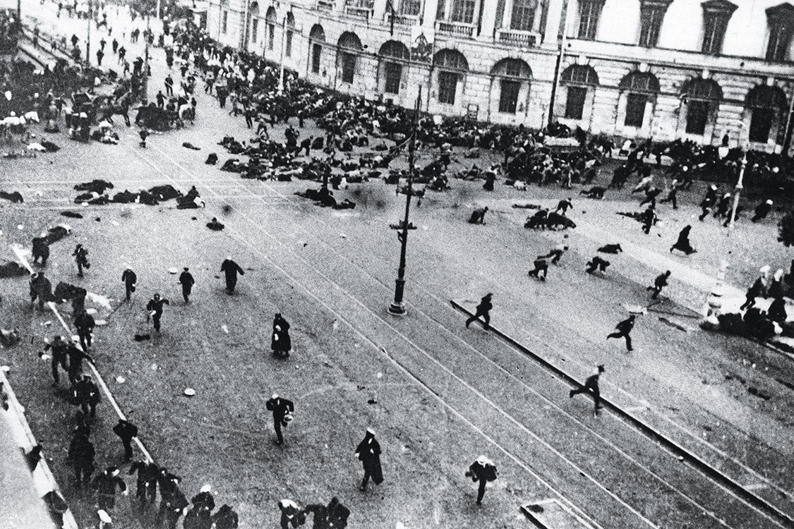 July 1917: Crowds flee from street fighting between Leninists and troops loyal to the the Kerensky provisional government outside the Duma (Russian State Assembly) on the corner of Nevsky Prospect, opposite the Saltikov-Schredin Library, Moscow, during the Russian Revolution. (Photo by Bulla/Slava Katamidze Collection/Getty Images)