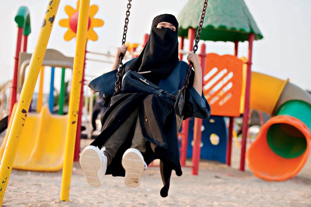 A Saudi woman swings at a park in Jeddah, Saudi Arabia, October 3, 2017. REUTERS/Reem Baeshen NO RESALES. NO ARCHIVE. TPX IMAGES OF THE DAY