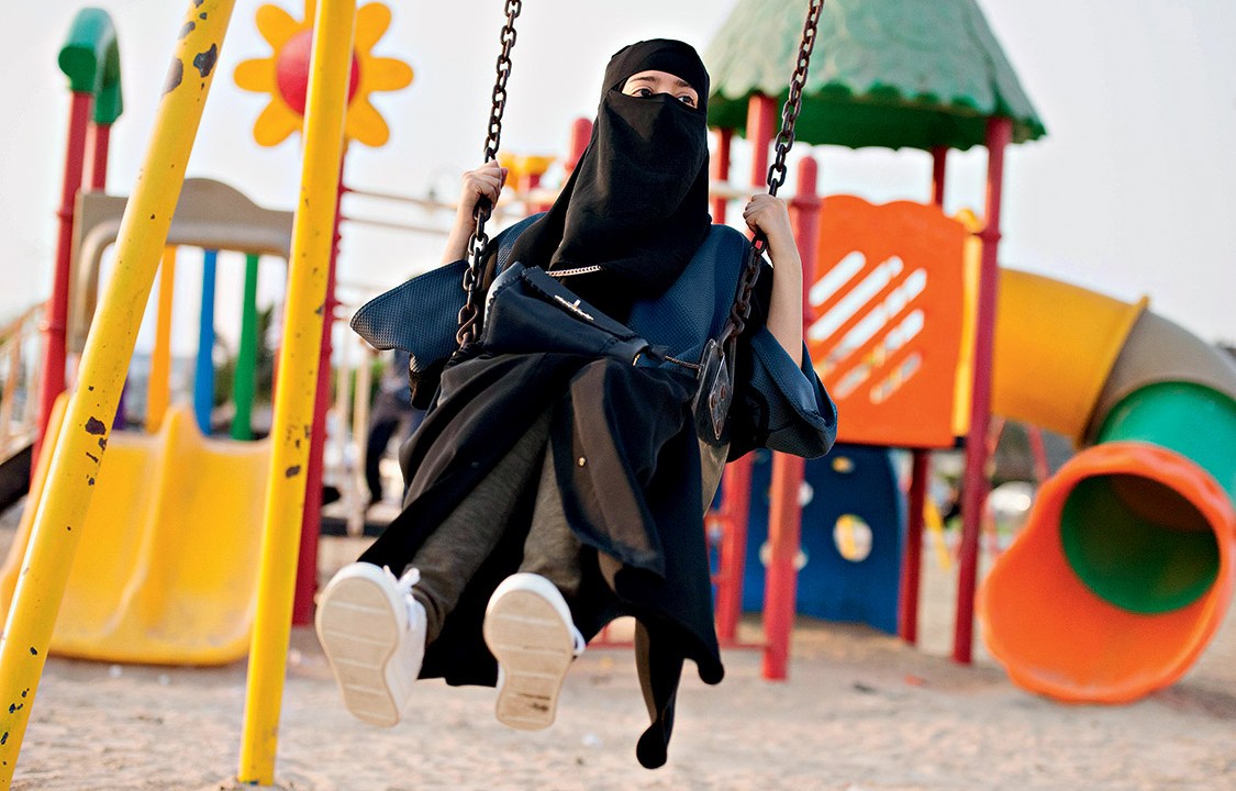 A Saudi woman swings at a park in Jeddah, Saudi Arabia, October 3, 2017. REUTERS/Reem Baeshen NO RESALES. NO ARCHIVE. TPX IMAGES OF THE DAY