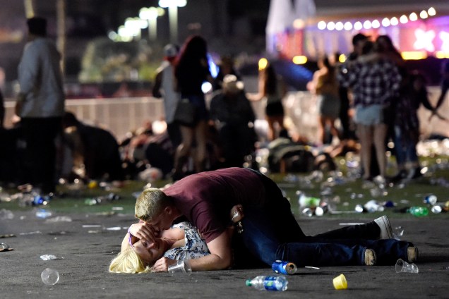 Homem abraça uma mulher ferida após um ataque a tiros durante um festival de música country em Las Vegas, nos Estados Unidos - 02/10/2017