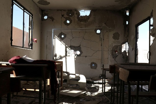 Sala de aula é vista destruída após bombardeios na cidade de Hass, Síria
