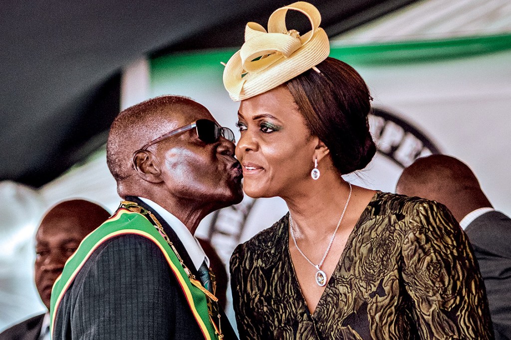 (FILES) This file photo taken on April 18, 2017 shows President Robert Mugabe kissing his wife and first lady Grace Mugabe during during the country's 37th Independence Day celebrations at the National Sports Stadium in Harare. Zimbabwe's military appeared to be in control of the country on November 15, 2017 as generals denied staging a coup but used state television to vow to target "criminals" close to President Robert Mugabe. Mnangagwa's dismissal left Mugabe's wife Grace, 52, in prime position to succeed her husband as the next president -- a succession strongly opposed by senior ranks in the military. / AFP PHOTO / Jekesai NJIKIZANA