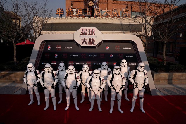 Atores vestidos de Stormtroopers se posicionam em frente ao Resort da Disney em Xangai, na China, durante estreia do filme - 20/12/2017