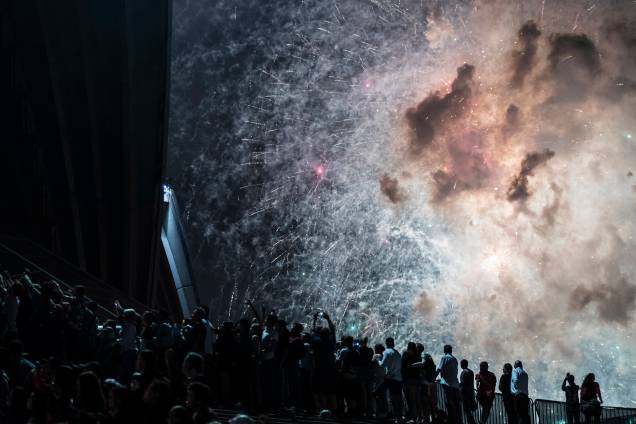 Multidão observa os fogos de artifício na Opera House durante as celebrações de Ano Novo em Sydney, na Austrália Multidão observa os fogos de artifício na Opera House durante as celebrações de Ano Novo em Sydney, na Austrália