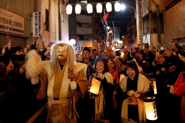Pessoas vestidas como raposas celebram a chegada do ano novo nas ruas de Tóquio, Japão