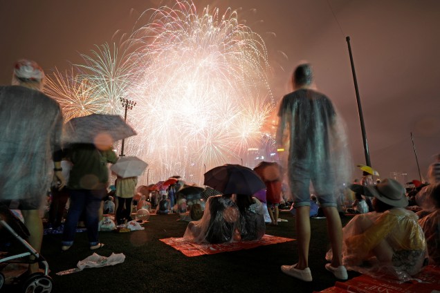 Pessoas vêem fogos de artifício em meio a chuva durante as celebrações do Ano Novo na Marina Bay, em Singapura