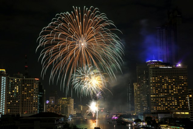 Fogos de artifício explodem sobre o rio Chao Phraya, em Bangcoc, capital da Tailândia, durante a celebração do Ano Novo