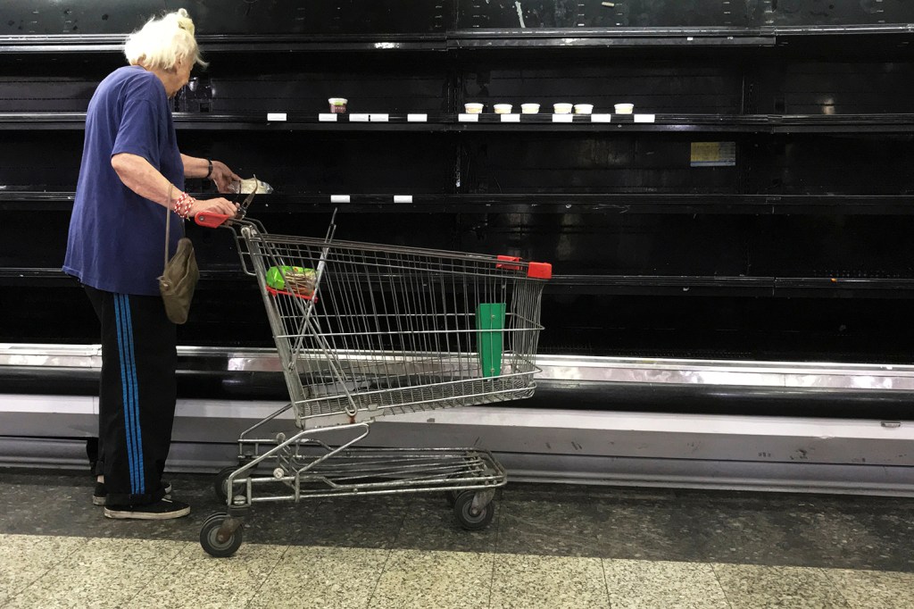 Mulher observa prateleira vazia em um supermercado de Caracas, na Venezuela - 10/01/2018
