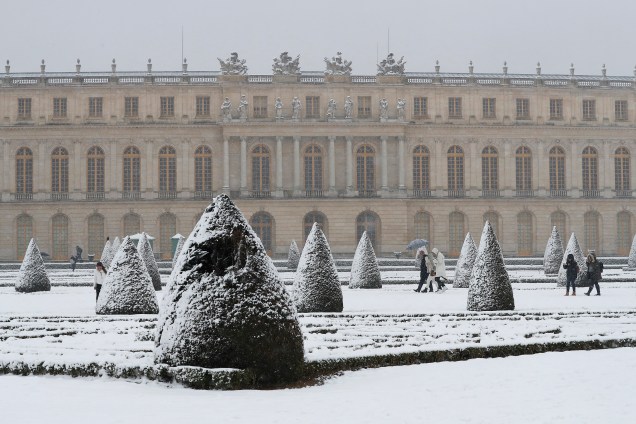Pessoas atravessam os jardins do Palácio de Versalhes, cobertos de neve, após forte nevasca que atingiu o norte da França - 06/02/2018