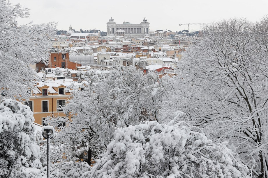 Uma vista panorâmica mostra tetos de casas, edifícios e copas de árvores cobertos pela neve que transformou a paisagem da cidade de Roma, na Itália - 26/02/2018