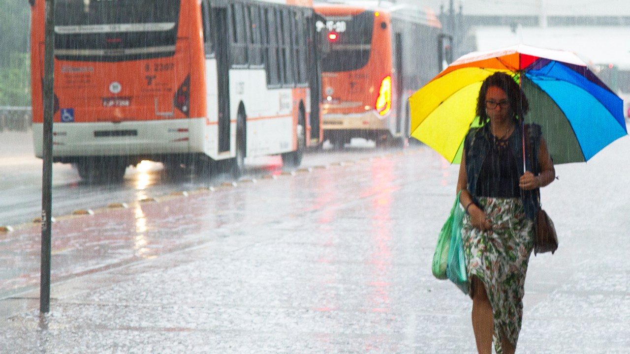 Pedestres se protegem da chuva, na região do Viaduto do Chá, no centro de São Paulo (SP) - 20/03/2018