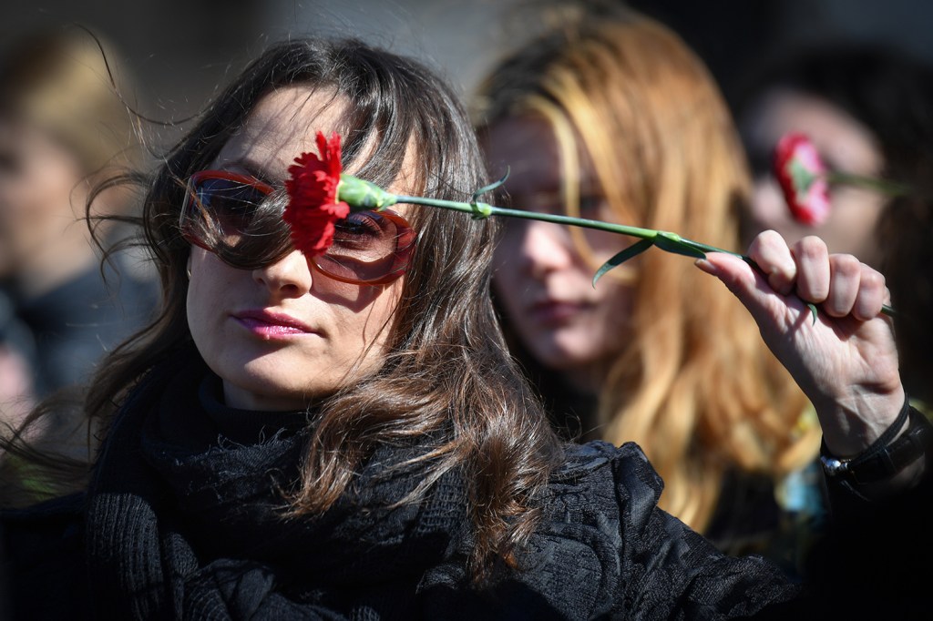 Mulher segura uma flor durante protesto contra a violência doméstica, em Bucareste, capital da Romênia, no Dia Internacional da Mulher - 08/03/2018