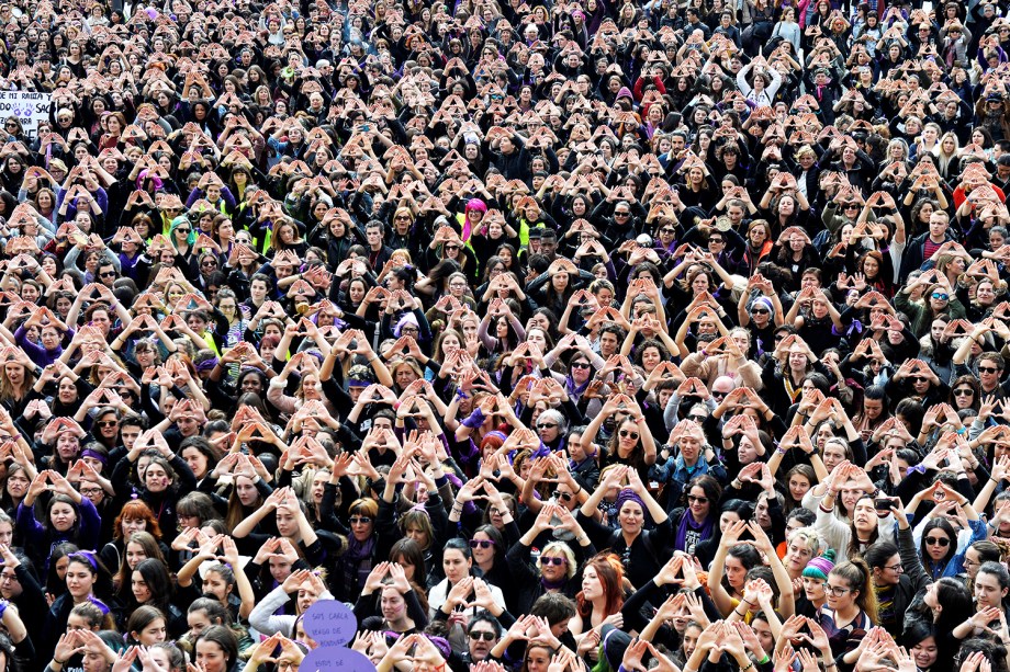 Mulheres fazem triângulos com as mãos durante protesto em defesa dos direitos femininos, em Bilbao, na Espanha - 08/03/2018
