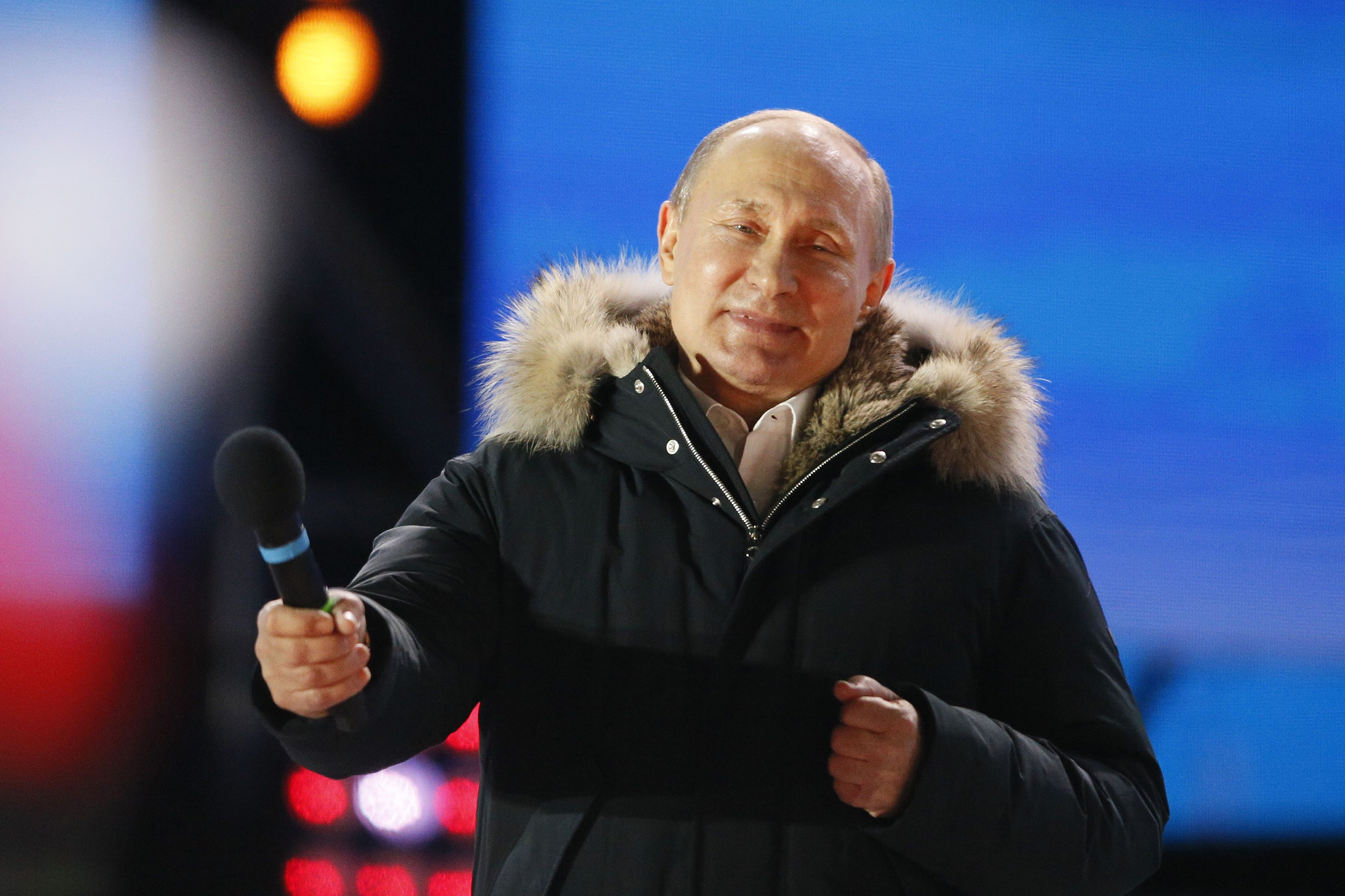 Russian President and Presidential candidate Vladimir Putin attends a rally and concert marking the fourth anniversary of Russia's annexation of the Crimea region, at Manezhnaya Square in central Moscow, Russia March 18, 2018. REUTERS/