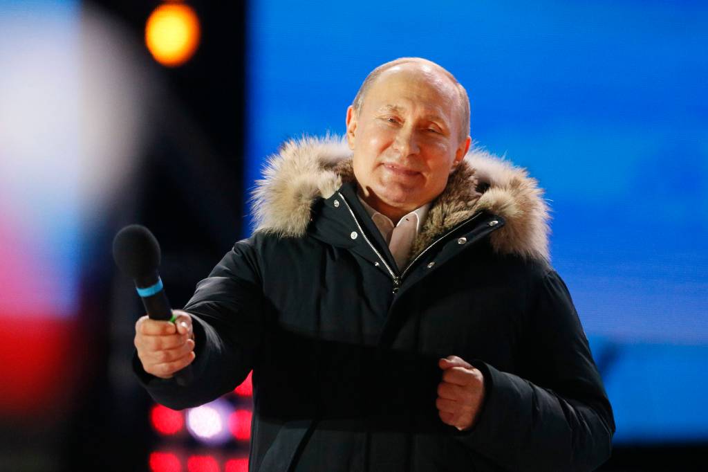 Russian President and Presidential candidate Vladimir Putin attends a rally and concert marking the fourth anniversary of Russia's annexation of the Crimea region, at Manezhnaya Square in central Moscow, Russia March 18, 2018. REUTERS/