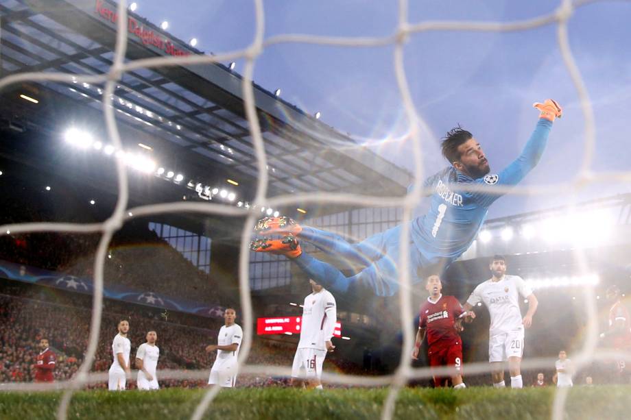 O goleiro brasileiro Alisson Becker da Roma salta mas não consegue evitar o gol do atacante egípcio Mohamed Salah do Liverpool - 24/04/2018