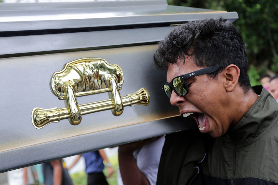 Parente do manifestante Gerald Velazquez, morto a tiros durante confrontos com a polícia em uma igreja perto da Universidade Nacional Autônoma da Nicarágua, carrega o caixão durante seu funeral, em Manágua - 16/07/2018