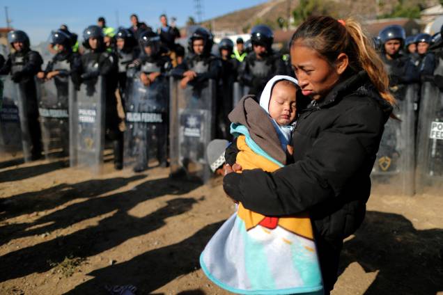 Rosa Villa, de 30 anos, carrega seu filho de cinco meses de idade na fronteira entre o México e os Estados Unidos, na cidade de Tijuana - 25/11/2018