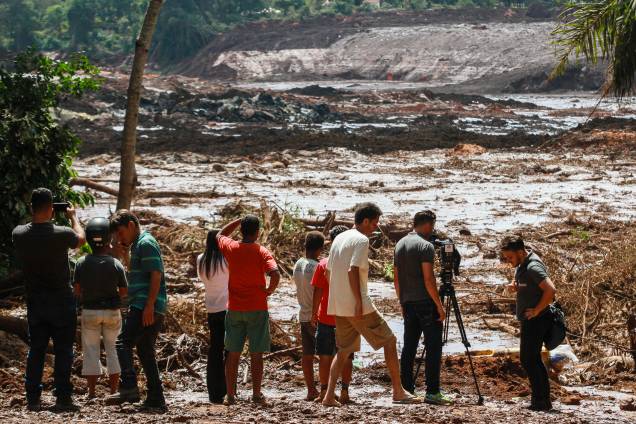 Pessoas observam o mar de lama após o rompimento de uma barragem na mina de ferro do Feijão, em Brumadinho (MG) - 25/01/2019
