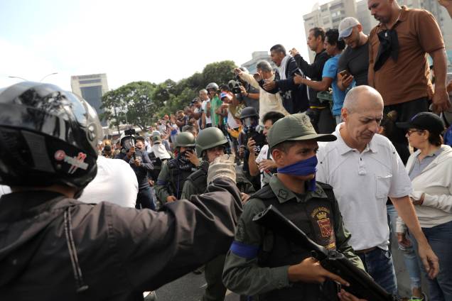 Pessoas reagem à presença de militares nos arredores da Base Aérea "La Carlota", em Caracas, na Venezuela - 30/04/2019