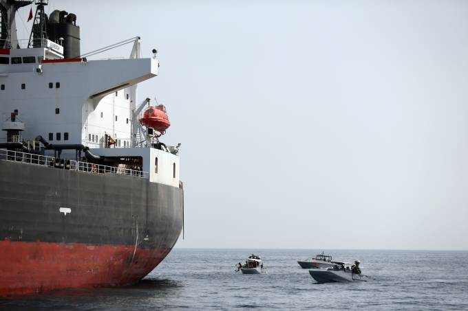 UAE Navy boats next to Al Marzoqah Saudi Arabia tanker are seen off the Port of Fujairah
