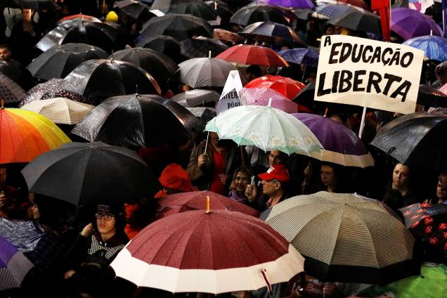 Manifestantes são vistos com guarda-chuva durante protesto contra cortes nas universidades, na frente da Universidade Federal do Paraná, em Curitiba (PR) - 30/05/2019