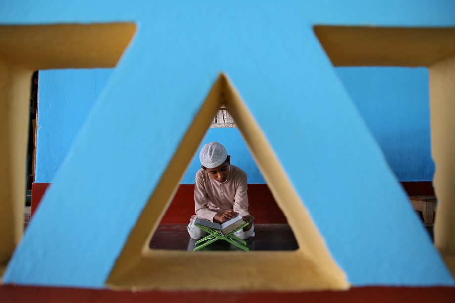 Menino muçulmano lê o Alcorão dentro de uma mesquita no primeiro dia do mês sagrado de jejum do Ramadã, nos arredores de Agartala, Índia - 07/05/2019