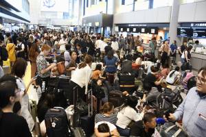 Passengers are stranded after railways and subway operators suspended their services due to Typhoon Faxai, at Narita airport in Narita
