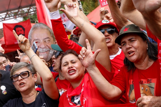 Apoiadores do ex-presidente do Brasil, Luiz Inácio Lula da Silva, fazem um gesto fora da sede da Polícia Federal, em Curitiba