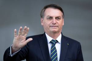Brazil’s President Jair Bolsonaro greets the media prior to a meeting of leaders of the BRICS emerging economies at the Itamaraty palace in Brasilia