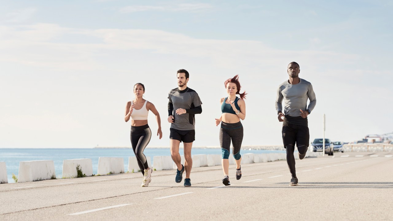 Group of sportspeople jogging at harbour