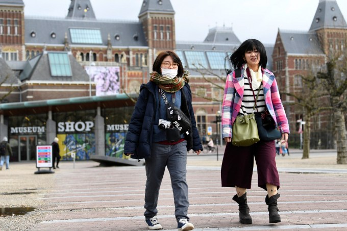 Tourists are confronted with a closed Rijksmuseum because of the coronavirus outbreak